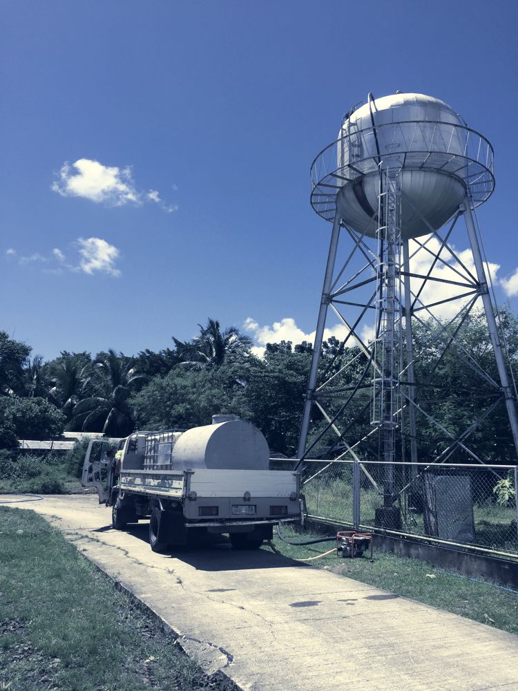 Overhead water tower with a service truck